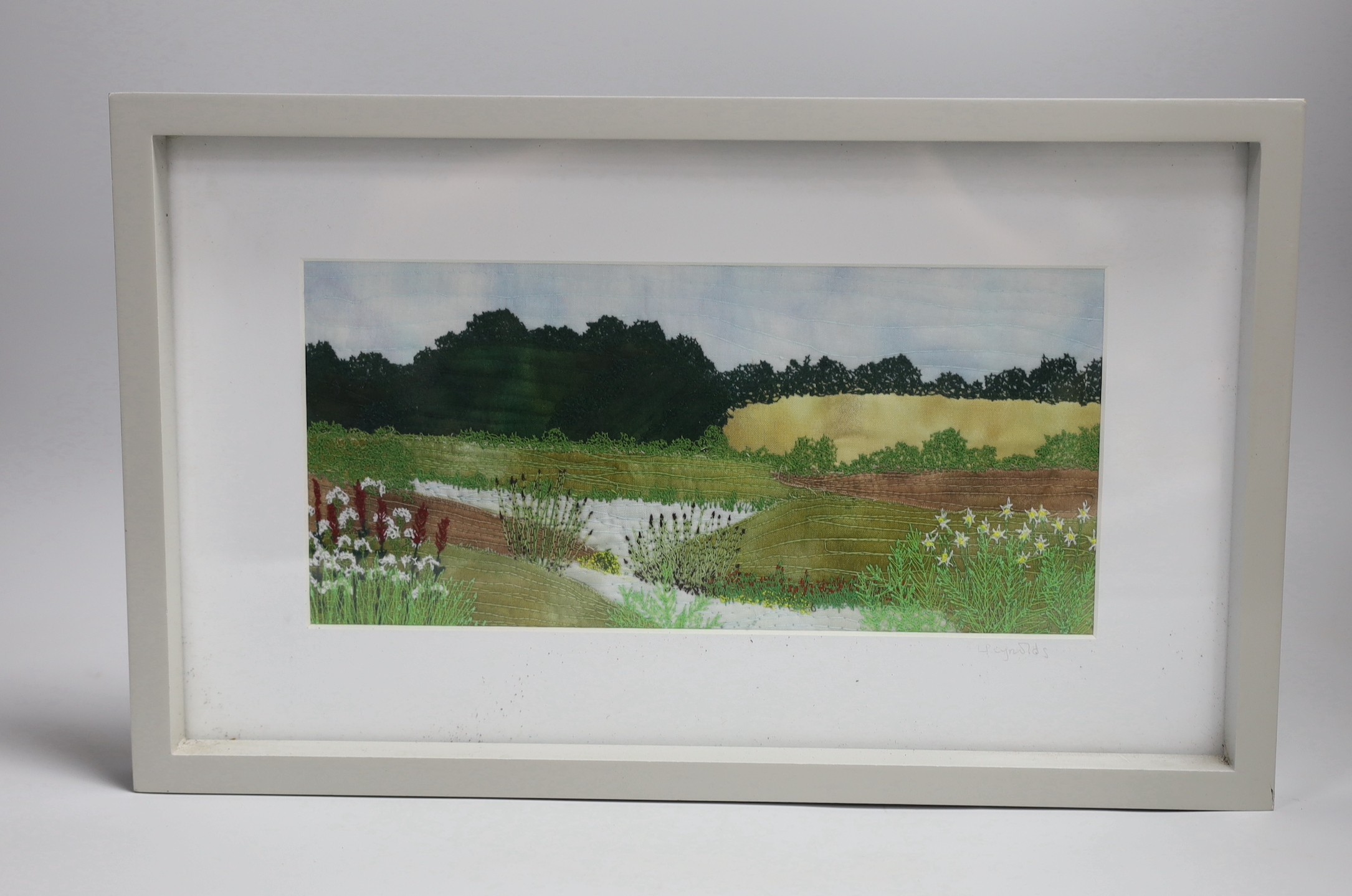 Textile landscape design by L Reynolds. Signed outside the plate. 14 x 29cm